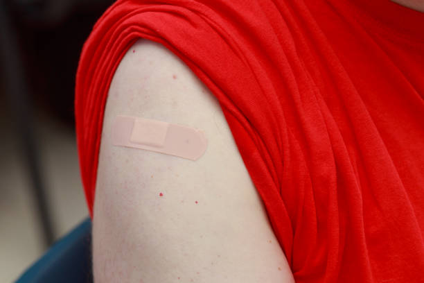 istock Patients shoulder with sealed plaster after coronavirus vaccination. Real procedure and situation 1362977505