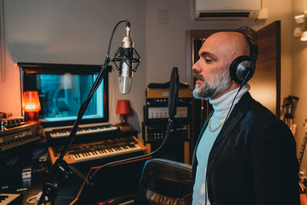 istock Singer is recording music in a professional recording studio 1362977589
