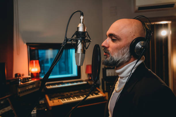 istock Singer is recording music in a professional recording studio 1362977592