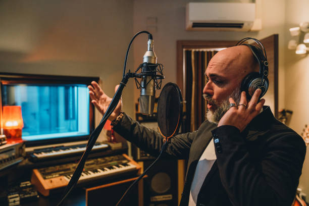 istock Singer is recording music in a professional recording studio 1362977597