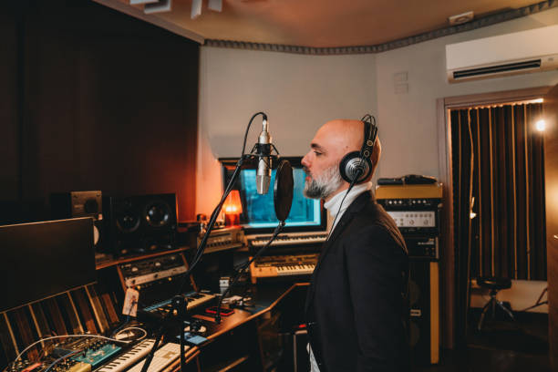 istock Singer is recording music in a professional recording studio 1362977606