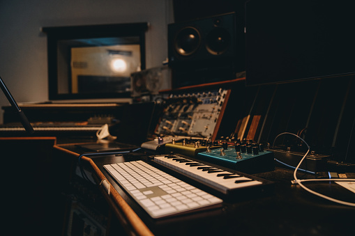 Shot of man's hand operating with sound recording studio mixer.