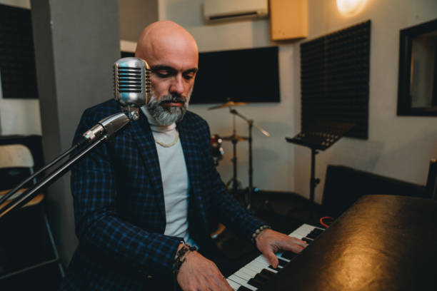 istock A musician is playing piano in a professional recording studio 1362977691