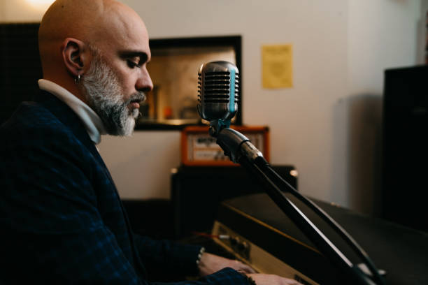 istock A musician is playing piano in a professional recording studio 1362977693