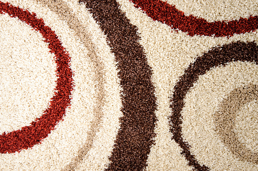 Beige rug with red and brown circles pattern