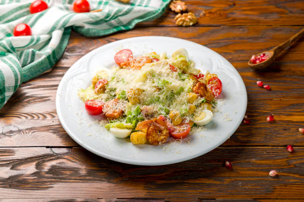 istock salad caesar with shrimps on white plate on wooden table 1362983817