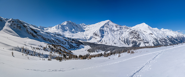 Panorama of an idyllic winter landscape in Austria, in the background is the impressive Hohe Sonnblick summit with the Sonnblick Weather Observatory, Rauris, Pinzgau, Salzburger Land