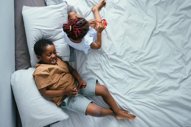 istock Top View of Siblings Playing in Bed 1362988711