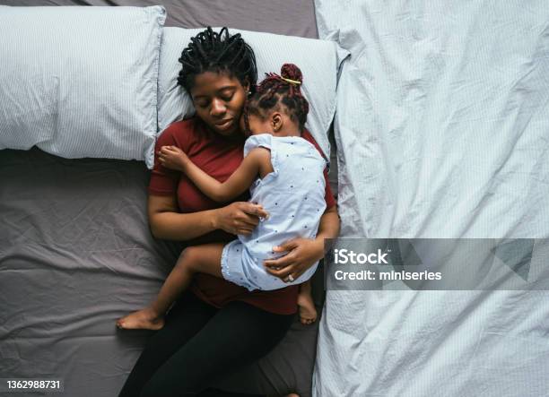Top View Of Beautiful Mother With Little Daughter Sleeping In Bed Stock Photo - Download Image Now