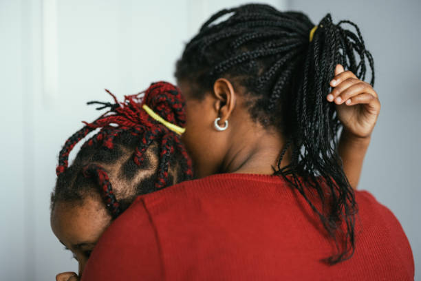 istock Unrecognizable Mother Embracing her Daughter in Bedroom 1362988748
