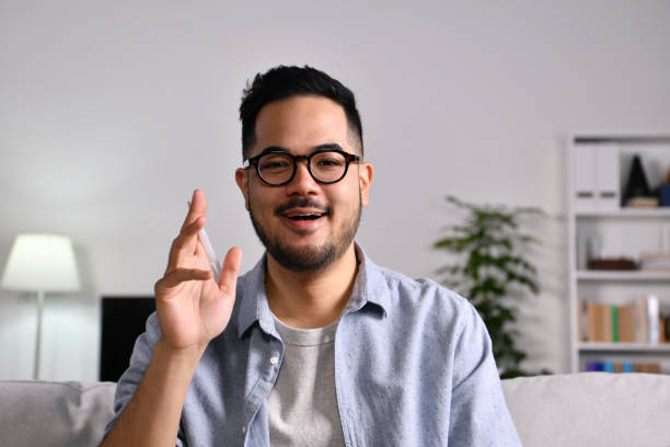 istock Young Asian businessman makes video call look at camera talking 1362993270