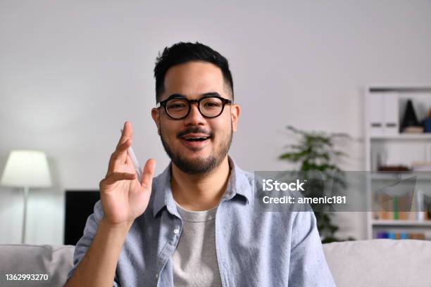 Young Asian Businessman Makes Video Call Look At Camera Talking Stock Photo - Download Image Now