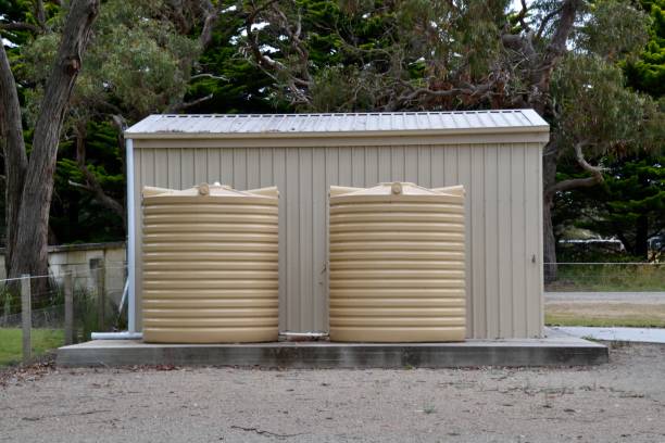 Sustainable building shed on Australian farm with two water tanks fed by water run off the metal roof stock photo