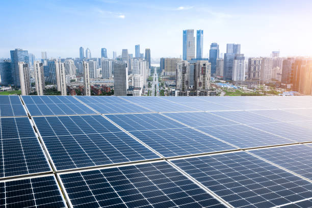 istock Photovoltaic panels in front of city background 1363007749