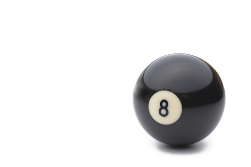 Close up of black eighth billiard ball against white background
