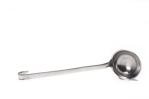Close up of silver metal soup ladle on white background