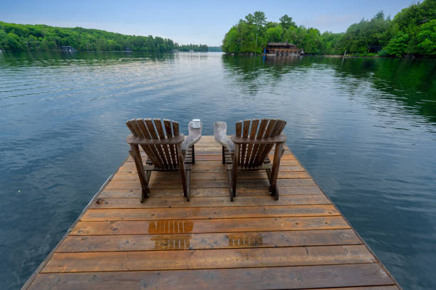 istock Two Adirondack chairs with enamel mug of coffee or tea 1363024692