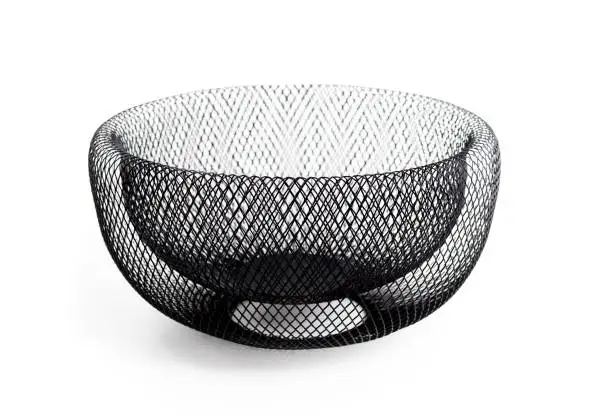 Decorative large double walled wire mesh dish or basket. Used to store, organize or showcase items such as fruit, bread, candy and snacks. Isolated on white. Selective focus.