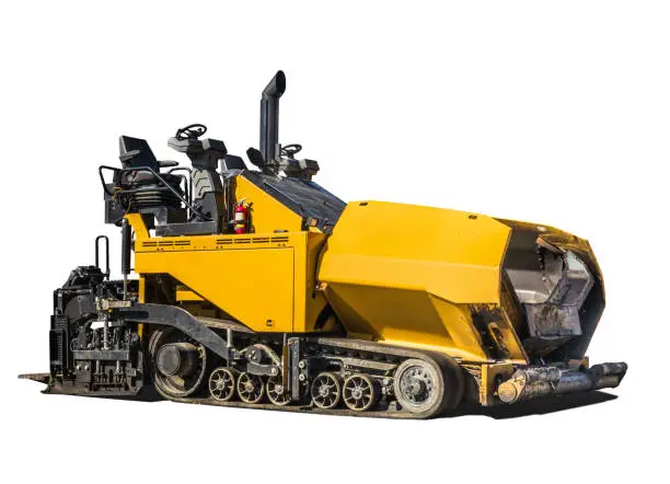 Yellow road construction vehicle, with exposed drivers seat. Rubber truck paver. Isolated on white.