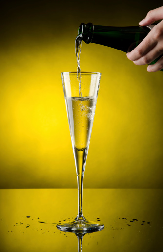 Glass of Champagne with yellow background