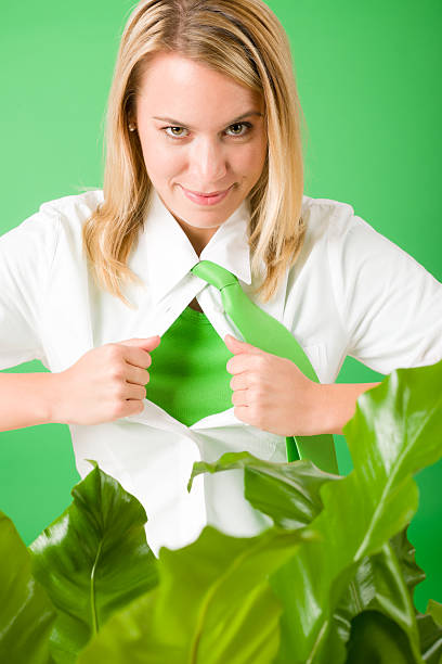 Superhero Businesswoman confident face green plant Superhero Businesswoman confident face green plants emerges from shirt superhero environment women green color stock pictures, royalty-free photos & images