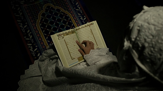 Muslim Woman Reading Verses from Holy Quran