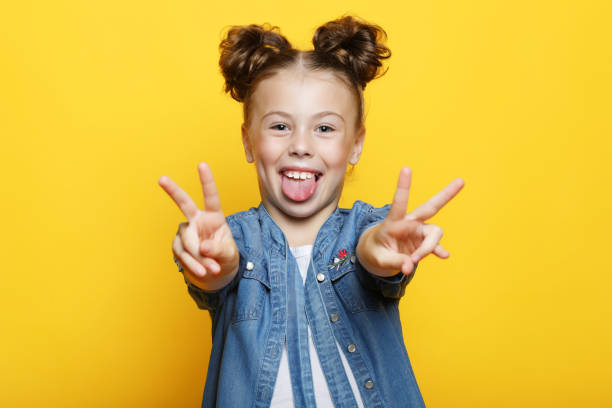 istock Little girl showing two hands with victory gesture 1363033238
