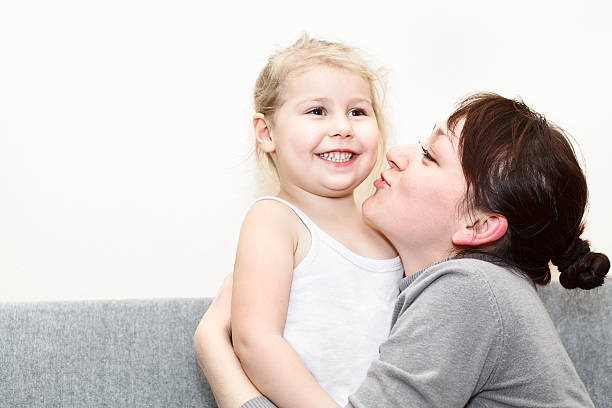 istock Mother and her little daughter embracing 136303324