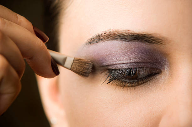 istock Woman's hand applying makeup brush to eyes 136303546