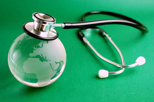 istock Stethoscope and crystal globe on green background 136303664