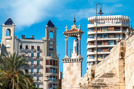 Statue of San Pascual Bailon (1940) by José Ortells López on Puente del Mar (Sea Bridge) in Valencia, Spain, with private apartments in the  background.