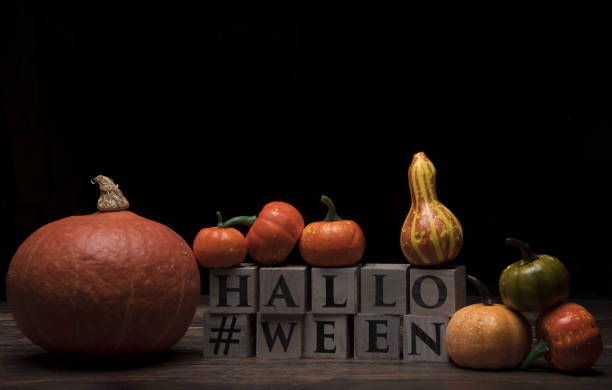 istock Various pumpkins on wooden cubes for Halloween 1363039620
