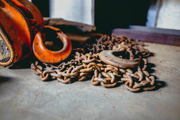 istock A rusty chain hoist lay on the cement floor of the workshop. 1363039703