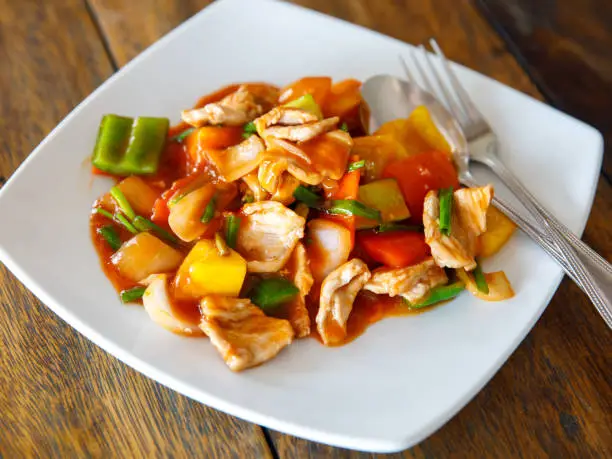 Sweet and sour stir fried pork, thai traditional food with pineapple, cucumber, tomato and other vegetable