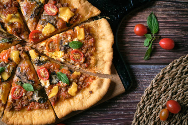istock Fresh baked thin crust Italian pizza with tomato sauce pepper cheese and basil leaf on Dark rustic table background. 1363041376