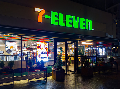 Stockholm, Sweden - December 19, 2021: Vertical Night View of 7-Eleven Convenience Store in Downtown Stockholm.