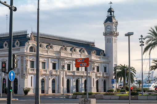 Clock Tower of the Port Authority Harbour Office in Valencia, Spain, with people visible in the distance