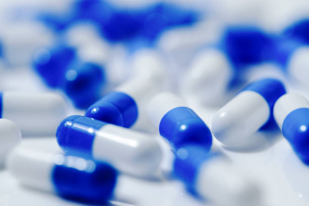 istock Medical image of blue and white capsule tablets 1363046440