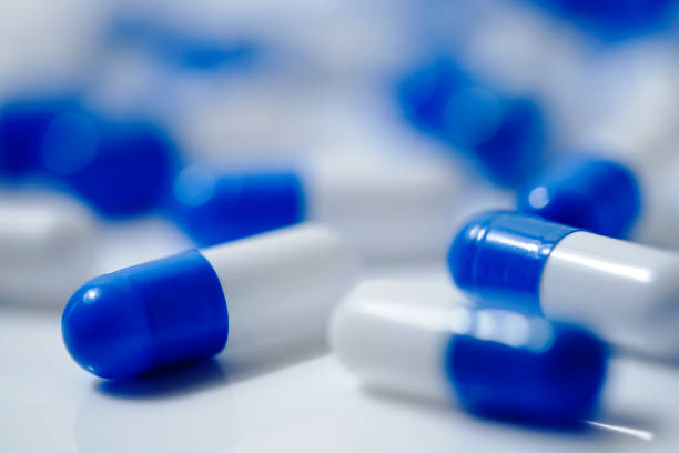 istock Medical image of blue and white capsule tablets 1363046443