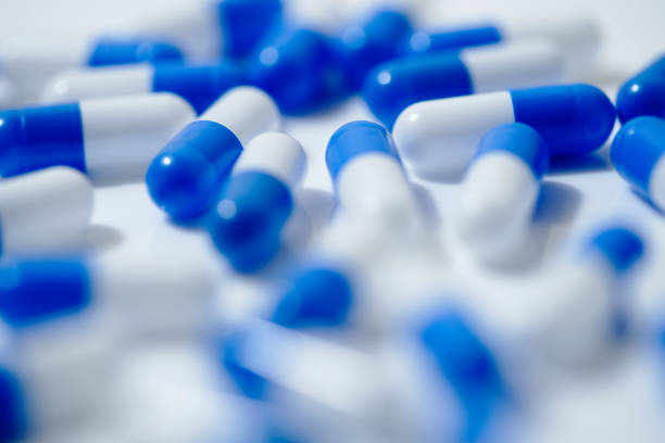 istock Medical image of blue and white capsule tablets 1363046453