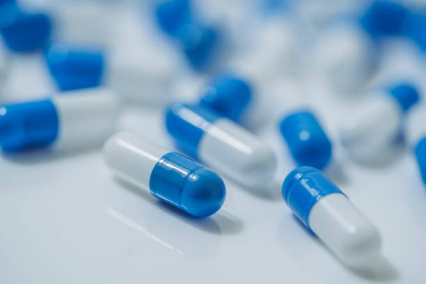 istock Medical image of blue and white capsule tablets 1363046454