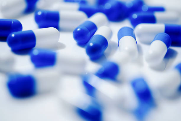 istock Medical image of blue and white capsule tablets 1363046468