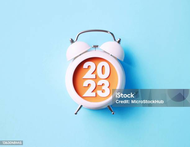 2023 Reads Over White Alarm Clock On Blue Background Stock Photo - Download Image Now