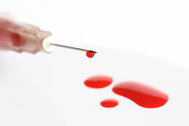 istock Plastic syringe with drops of blood 136305126