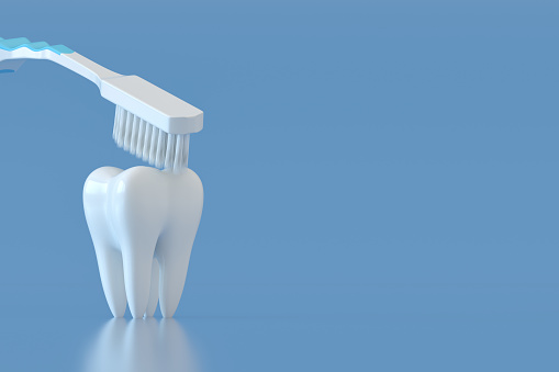 Toothbrush and white tooth on a blue background dental care
