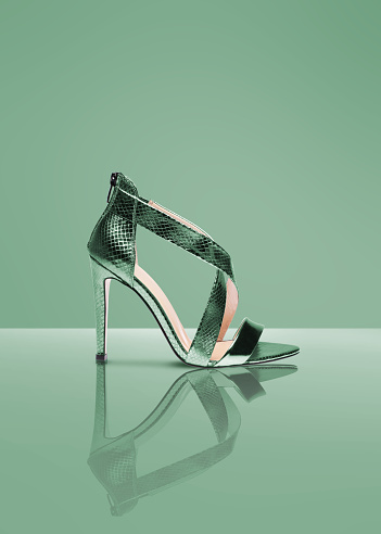 Cut out image of a studio shot green color shoe on green background