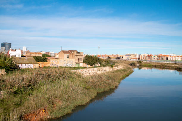 Turia River in Downtown District of Valencia, Spain, with graffiti on the walls in the background