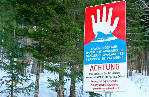 Carinthia, Austria - December, 2021: A sign warning of the danger of avalanches (in German).