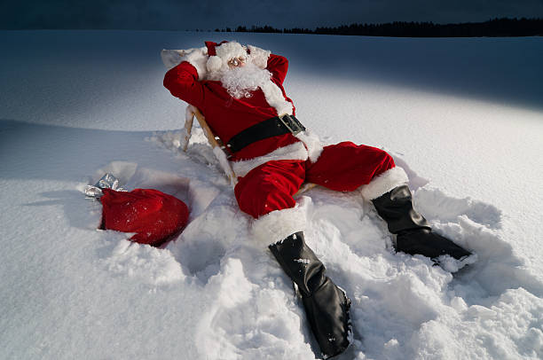 Santa relaxing on a sunbed stock photo