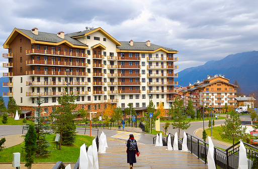 Rosa Khutor, Sochi, Russia, 11.01.2021. Streets of the Olympic village. Mountain village with new hotels under a cloudy sky